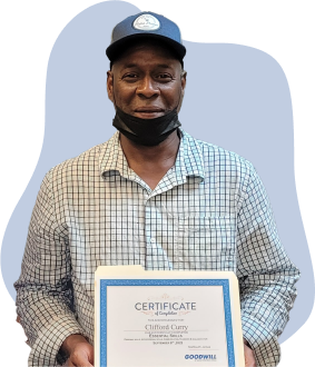 Photograph of Clifford Curry holding an Essential Skills certification